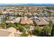 Beautiful aerial view of a home featuring a backyard pool, desert landscaping, and a lushly landscaped community at 77 Chapman Heights St, Las Vegas, NV 89138