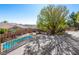 Elevated backyard view featuring a pool, patio area, and mature landscaping at 77 Chapman Heights St, Las Vegas, NV 89138