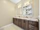 Bathroom features a dual sink vanity with marble countertop and custom backsplash at 77 Chapman Heights St, Las Vegas, NV 89138