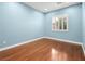 Bedroom with hardwood floors, natural light, and blue painted walls at 77 Chapman Heights St, Las Vegas, NV 89138