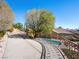 Elevated curved driveway leads to a home with a pool in a serene, landscaped setting at 77 Chapman Heights St, Las Vegas, NV 89138