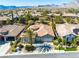 Beautiful single-story home featuring lush desert landscaping, a two-car garage and mountain views at 77 Chapman Heights St, Las Vegas, NV 89138