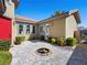 Private courtyard featuring beautiful pavers, a fire pit, and lush landscaping at 77 Chapman Heights St, Las Vegas, NV 89138