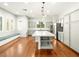 Bright kitchen featuring a large island with marble countertop, stainless steel appliances, and hardwood floors at 77 Chapman Heights St, Las Vegas, NV 89138