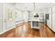 Bright kitchen featuring a large island with marble countertop, stainless steel appliances, and hardwood floors at 77 Chapman Heights St, Las Vegas, NV 89138