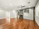 Open living room featuring hardwood floors, built in shelves, modern fireplace, and lots of light at 77 Chapman Heights St, Las Vegas, NV 89138