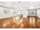 Bright and airy living room featuring hardwood floors, large windows, and a modern ceiling fan at 77 Chapman Heights St, Las Vegas, NV 89138