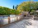 An expansive stainless outdoor kitchen includes a built-in grill, and countertop space alongside a stone outdoor fireplace at 77 Chapman Heights St, Las Vegas, NV 89138