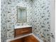 Stylish powder room with bird-themed wallpaper, wood vanity, and modern fixtures at 77 Chapman Heights St, Las Vegas, NV 89138