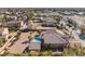 Expansive aerial view of a desert home, complemented by palm trees and a sparkling blue pool at 7860 Thunder Echo St, Las Vegas, NV 89131