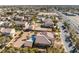 Spacious aerial view of a desert home, enhanced by palm trees and a clear blue pool at 7860 Thunder Echo St, Las Vegas, NV 89131