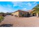 Exterior view of a home with neutral paint, desert landscaping, and a fenced-in entrance at 7860 Thunder Echo St, Las Vegas, NV 89131