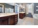 Well-lit bathroom with double sink vanity, soaking tub, and tile flooring at 7860 Thunder Echo St, Las Vegas, NV 89131