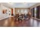 Elegant dining room with hardwood floors, a large table for eight, and views into the open-concept kitchen at 7860 Thunder Echo St, Las Vegas, NV 89131