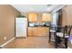 Functional kitchenette with white refrigerator, microwave and breakfast bar at 7860 Thunder Echo St, Las Vegas, NV 89131