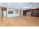 Open living room with tile flooring, a built-in entertainment center, and a cozy fireplace with custom cabinetry at 7860 Thunder Echo St, Las Vegas, NV 89131