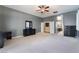 Large main bedroom boasting neutral carpeting, ceiling fan, and en suite bathroom at 7860 Thunder Echo St, Las Vegas, NV 89131