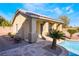 Beautiful backyard pool house with a red tile roof, and adjacent landscaped pool at 7860 Thunder Echo St, Las Vegas, NV 89131