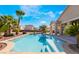 Beautiful in-ground pool with surrounding desert landscaping and manicured tropical trees at 7860 Thunder Echo St, Las Vegas, NV 89131