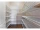 Spacious walk-in closet with multiple rows of shelving, offering ample storage space at 7860 Thunder Echo St, Las Vegas, NV 89131