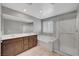 Bright bathroom features a double sink vanity, a soaking tub, and a glass enclosed shower at 7870 Formitch Ct, Las Vegas, NV 89166