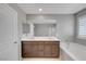 Bathroom with double sink vanity, soaking tub, and large mirror at 7870 Formitch Ct, Las Vegas, NV 89166