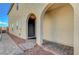 Entrance to home with brick walkway and steps and exterior in a light stucco at 7870 Formitch Ct, Las Vegas, NV 89166