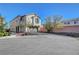 Two-story home with two-car garage and brick driveway under a clear blue sky, view from street at 7870 Formitch Ct, Las Vegas, NV 89166