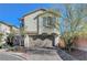 Two-story stucco home with a two-car garage and a brick driveway under a clear blue sky at 7870 Formitch Ct, Las Vegas, NV 89166