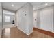 Bright hallway with wood floors, neutral walls, and white doors creates a welcoming and clean transition space at 7870 Formitch Ct, Las Vegas, NV 89166