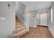 Staircase with carpeted steps and a white handrail, adjacent to the home's entrance at 7870 Formitch Ct, Las Vegas, NV 89166