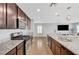 Modern kitchen featuring stainless steel appliances, granite countertops, and barstool seating at 7870 Formitch Ct, Las Vegas, NV 89166