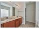 Main bathroom features double sink vanity, large mirror, and tiled floors at 8429 Spirit Vale Ave, Las Vegas, NV 89117