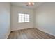 Bright bedroom featuring a ceiling fan, window, and attractive flooring at 8429 Spirit Vale Ave, Las Vegas, NV 89117