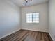 This bedroom has a ceiling fan, window and beautiful floors at 8429 Spirit Vale Ave, Las Vegas, NV 89117