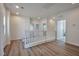 Bright upstairs hallway with wood floors and white banister at 8429 Spirit Vale Ave, Las Vegas, NV 89117