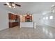 Open-concept kitchen featuring tile floors, a breakfast bar, and stainless steel appliances at 8429 Spirit Vale Ave, Las Vegas, NV 89117