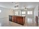 Kitchen island with cabinets and dishwasher, and granite countertops at 8429 Spirit Vale Ave, Las Vegas, NV 89117