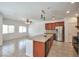 Open kitchen with stainless steel refrigerator, granite counters, and tile flooring at 8429 Spirit Vale Ave, Las Vegas, NV 89117