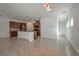 Open-concept kitchen featuring tile floors, stainless steel appliances, and a breakfast bar at 8429 Spirit Vale Ave, Las Vegas, NV 89117