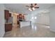 Open-concept kitchen featuring tile floors, ceiling fan, stainless steel appliances, and breakfast bar at 8429 Spirit Vale Ave, Las Vegas, NV 89117