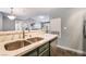 Open kitchen layout with stainless steel sink and modern lighting fixtures at 8452 Boseck Dr # 285, Las Vegas, NV 89145