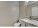 Modern powder room featuring a white vanity and sleek faucet fixtures at 8605 Wild Diamond Ave, Las Vegas, NV 89143