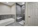 Modern bathroom features separate soaking tub and tiled shower with a built-in bench at 8605 Wild Diamond Ave, Las Vegas, NV 89143