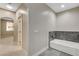 Bathroom with tub and tiled floor; doorway to another room is visible at 8605 Wild Diamond Ave, Las Vegas, NV 89143