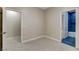 Bright, carpeted bedroom featuring two doorways to adjacent rooms and neutral paint at 8605 Wild Diamond Ave, Las Vegas, NV 89143