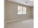 Neutral toned bedroom featuring carpet and a window at 8605 Wild Diamond Ave, Las Vegas, NV 89143