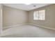 Neutral toned bedroom with soft carpet and large window at 8605 Wild Diamond Ave, Las Vegas, NV 89143