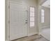 Inviting entryway featuring a white front door, neutral walls, and a combination of carpet and hardwood flooring at 8605 Wild Diamond Ave, Las Vegas, NV 89143