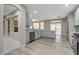 Large kitchen with stainless steel appliances, light gray cabinets, and breakfast bar that opens to the living space at 8605 Wild Diamond Ave, Las Vegas, NV 89143